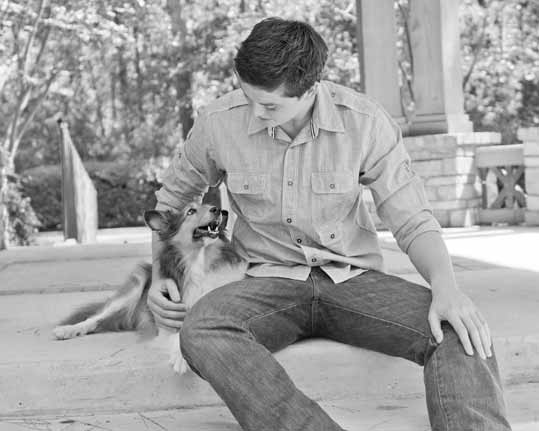 professional senior pictures of a boy and his dog