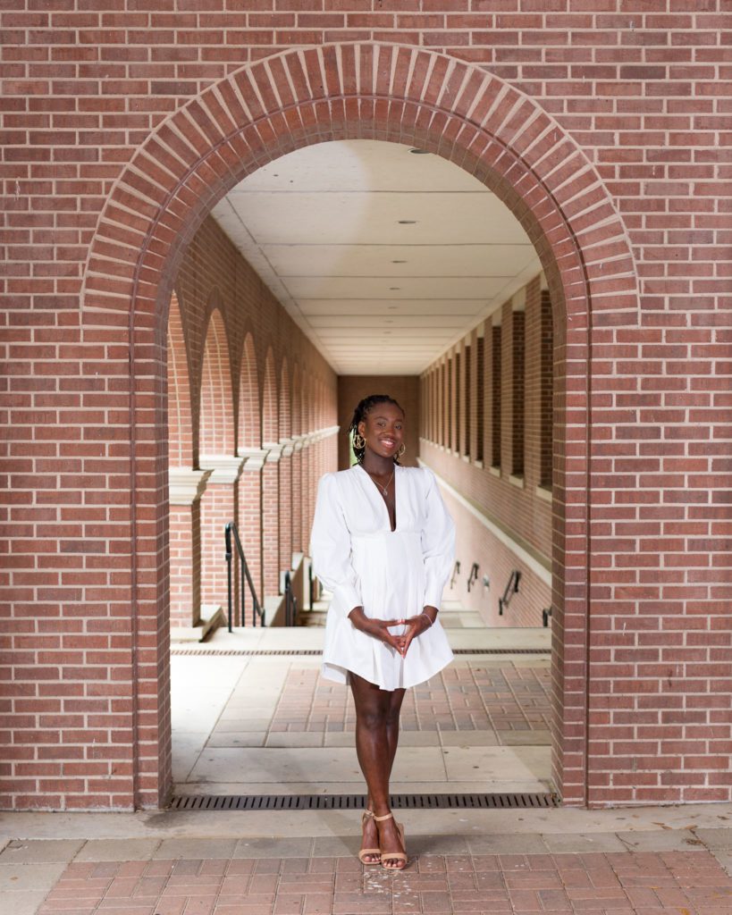 Image of black girl on college campus for college graduation picture ideas